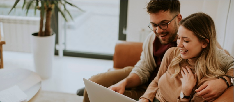 Handsome young couple using laptop 