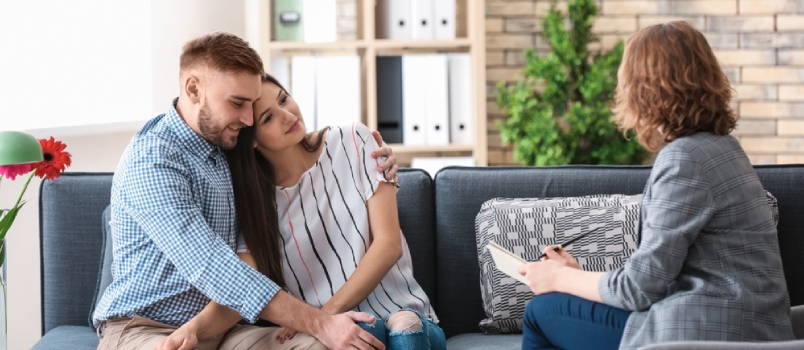 Psychologist Working With Married Couple In Office